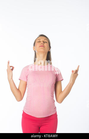 Pregnant woman doing yoga sur un fond blanc. Banque D'Images