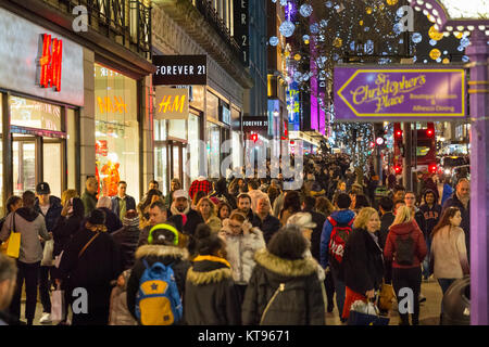 Oxford Street, Londres, 23 décembre 2017. Le soir avant la veille de Noël, le temps doux a produit des milliers d'acheteurs de dernière minute, la navigation sur les aubaines et présente, en appréciant les lumières de Noël et en longeant les trottoirs bondés. Credit : Imageplotter News et Sports/Alamy Live News Banque D'Images