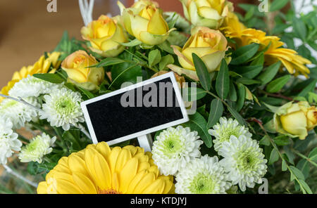 Bouquet de roses jaunes et blanches, gerbera, chrysanthèmes et petit blackboard with copy space Banque D'Images