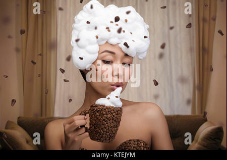 Portrait créatif de belle femme drôle avec cuvette et s'habiller dans les fèves de café Banque D'Images