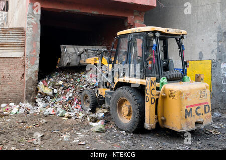 Chargeur avant déménagement gros tas de déchets urbains dans la région de Old Delhi, Inde Banque D'Images