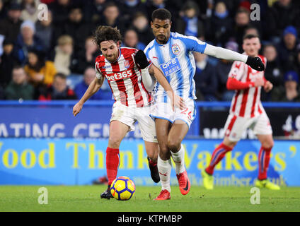 Stoke City's Joe Allen (à gauche) et Huddersfield Town's Steve Mounie bataille pour la balle durant le premier match de championnat à la John Smith's Stadium, Huddersfield. Banque D'Images