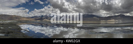 Lac de montagne sur une journée nuageuse : nuages lourds reflète dans le miroir de l'eau, panorama, Himalaya. Banque D'Images