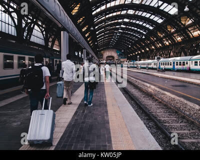 MILAN, ITALIE - 28 septembre 2011 : les voyageurs avec leurs bagages ont juste obtenu hors du train à la gare centrale de Milan. Les trains s'arrêtent sous la splendide couv Banque D'Images