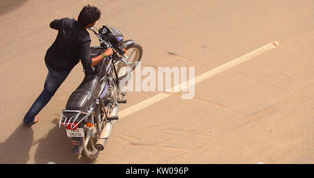 Un jeune homme déménagement La moto Vue du dessus. Banque D'Images