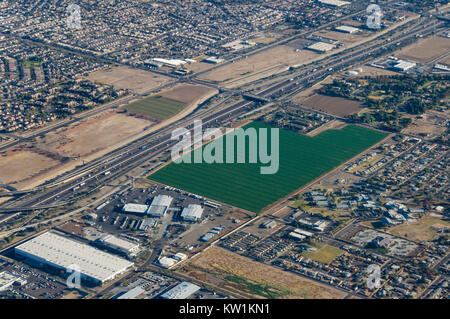 Vue aérienne des terres agricoles entouré par la construction résidentielle et industrielle Banque D'Images