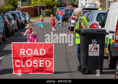 Une route est fermée par des bénévoles comme les enfants jouent dans la rue dans le cadre de la Bristol fondée 'jouant' Projet. Banque D'Images