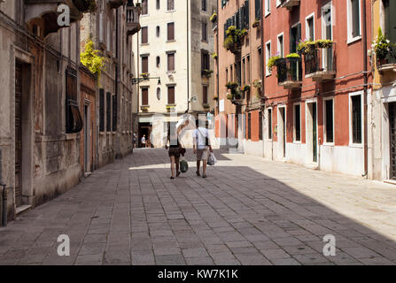 L'homme et la femme marche dans une rue de Venise / Italie. Banque D'Images