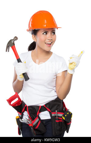 Une femme portant une ceinture à outils pleine d'une variété d'outils utiles et pointant vers le haut Banque D'Images