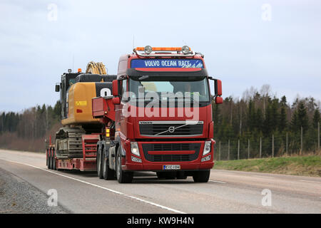 Mikkeli, Finlande - 17 MAI 2017 : Volvo FH Cat 336FL semi parcours grande excavatrice hydraulique sur remorque col de cygne, le long de la route au printemps. Banque D'Images