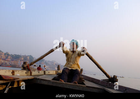 Bateau à rames sur l'homme de la rivière du Gange à Varanasi, Inde du nord. Banque D'Images