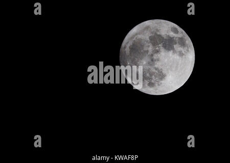 Northampton, Royaume-Uni le 1er janvier 2018. La première soirée de 2018 dispose de la plus grosse pleine lune de l'année à venir, connu comme une Supermoon c'est aussi connu comme le loup de la Lune, il s'allume le ciel en début de soirée, lorsqu'elle apparaît derrière les nuages. Credit : Keith J Smith./Alamy Live News Banque D'Images