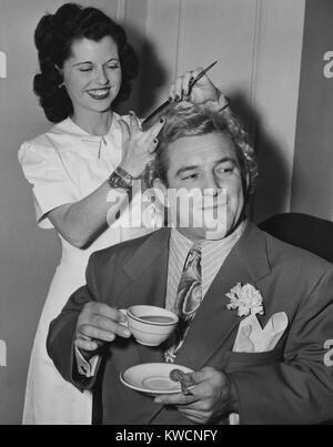 Wrestler Gorgeous George tenant une tasse de thé comme ses cheveux sont décorées par Mlle Bettie de Hollywood. 19 février, 1949. Il est apparu dans le film 1949, ALIAS LE CHAMP. - BSLOC  2014 (17 162) Banque D'Images