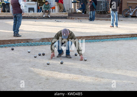 L'homme de prendre des mesures au cours du traditionnel jeu de boules ball français, ou de pétanque, à Cannes, Côte d'Azur, France Banque D'Images