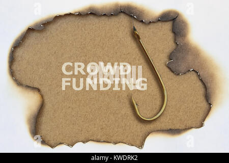 Crowdfunding texte et un crochet de pêche sur fond lumineux Banque D'Images