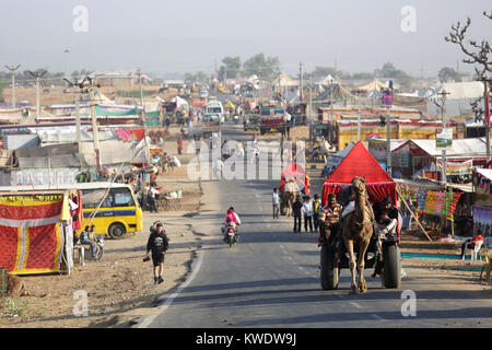 Scène à Pushkar Camel Camel Fair, panier et autres transports sur la route avec des stands sur les deux côtés, Pushkar, Rajasthan, India Banque D'Images