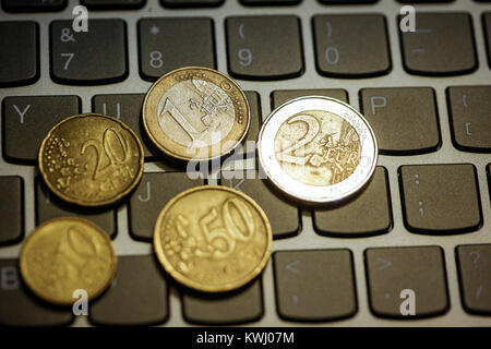 Pièces en euro sur le clavier de l'ordinateur portable - faire de l'argent en ligne Banque D'Images