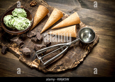 Crème glacée à la pistache fraîche dans un bol avec des tasses. Sur une table en bois. Banque D'Images