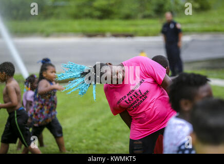 Davenport, Iowa, États-Unis. 24 juillet, 2017. Les voisins musicaux de l'été chef du programme parc Sharon Stepheny retourne ses cheveux pour le sécher à la Cork Hill Park à Davenport le lundi, Juillet 24, 2017. Davenport et incendie départements parcs font équipe pour visiter plusieurs quartiers et fournir une occasion pour les enfants et les adultes pour se rafraîchir dans l'eau dans le cadre de la ''Combattre la chaleur'' initiative qui a été mise en place depuis un certain nombre d'années. Credit : Andy Abeyta, Quad-City Times/Quad-City Times/ZUMA/Alamy Fil Live News Banque D'Images