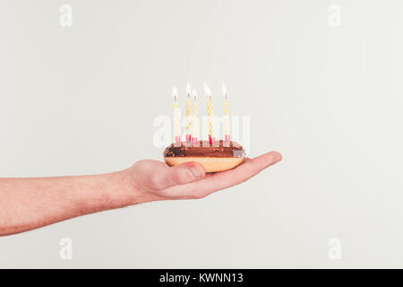 Cropped shot of woman eating with birthday candle Banque D'Images