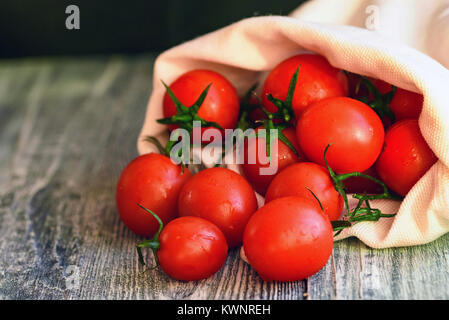 Tomates mûres rouges sortir de sac. Vue rustique Banque D'Images