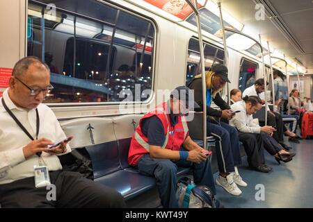 Les passagers et les employés de l'aéroport prenez l'Airtrain jusqu'à tard dans la nuit à l'Aéroport International John F Kennedy (JFK), Queens, New York, le 13 septembre 2017. Banque D'Images