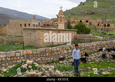 Vue sur le village abandonné de Killit, près de la ville de Savur à Mardin avec un garçon local. Le village était habité par des chrétiens orthodoxes syriens. Banque D'Images