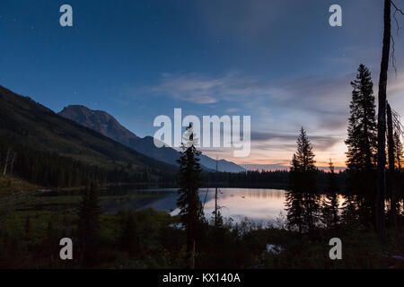Les eaux calmes du lac de chaîne de montage reflétant Moran et une aube à Jackson Hole. Parc National de Grand Teton, Wyoming Banque D'Images