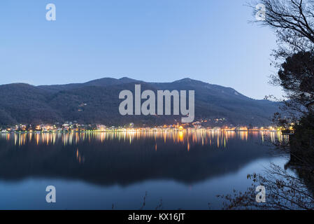 La ville de Porto Ceresio, Italie, à la frontière avec la Suisse, au crépuscule, en hiver. Orsa montage à l'arrière-plan. Province de Varese Banque D'Images