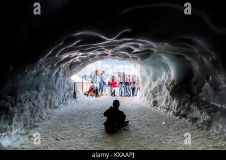 Les touristes qui pose pour photo en face de l'entrée de style grotte de glace, Chamonix Mont Blanc, Haute Savoie, France Banque D'Images