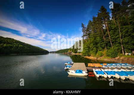 Paysage de montagne avec les quais et les bateaux sur le lac à vélo pédale Gozna entouré par la forêt, Valiug, Caras-Severin, Roumanie Banque D'Images