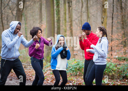 Déterminé les jeunes en phase de préchauffage avec mouvements de boxe Banque D'Images