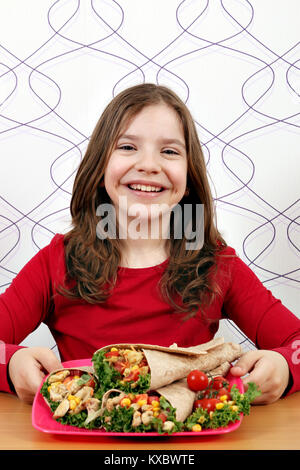 Happy little girl manger des burritos Banque D'Images