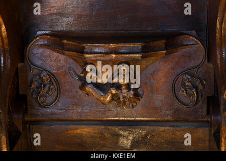 Royaume-uni, Angleterre, Cheshire, Nantwich, St Mary's Church, chorale, 14e siècle scène intérieure, femme assise faisant d'aiguille, avec chien misericord Banque D'Images