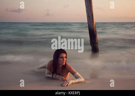 Belle femme en robe blanche sur la plage Banque D'Images