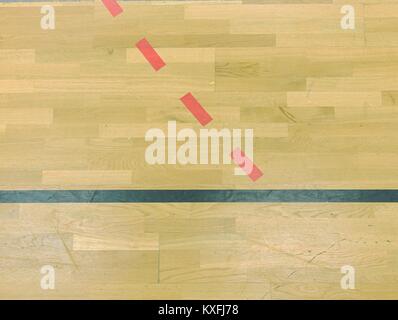 Parquet dans la salle de sport avec de solides et des lignes en pointillé. Réflexion de la lumière sur du parquet ciré avec lignes de marquage coloré Banque D'Images