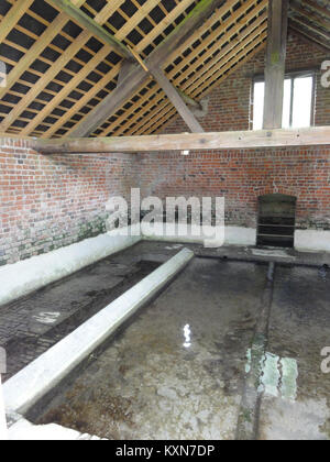 Vue intérieure de la laverie publique (lavoir) à Besmont, Aisne, montrant la structure historique et la fonction de la vie communautaire en France rurale. Banque D'Images