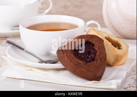 Abricot et framboise rempli hamantash les cookies et une tasse de thé Banque D'Images