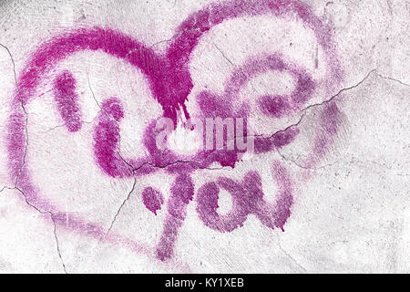 Le mot amour avec cœur brisé peint comme un graffiti sur mur de béton. Tomber en amour et de la Saint-Valentin concept. Banque D'Images