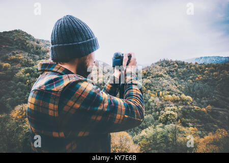 Photographe homme photo de montagne Vie Voyage adventure concept vacances actives dans la nature portant chemise à carreaux et un chapeau confortable Banque D'Images