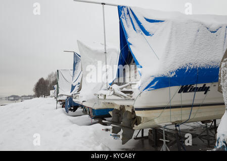 Les bateaux de plaisance enregistrés sur la terre ferme dans une marina en hiver en Norvège. Banque D'Images