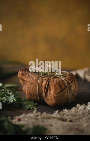 Morceau de lard fumé salé dans la gaze avec une corde.repas russes et ukrainiennes traditionnelles.Alimentation saine avec pranami épices, herbes, l'oignon et l'ail.Food Banque D'Images