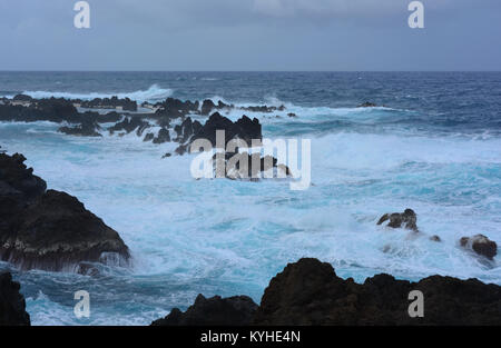 Le temps orageux. Vagues se brisant sur les rochers de lave volcanique à Porto Moniz, Madeira Banque D'Images