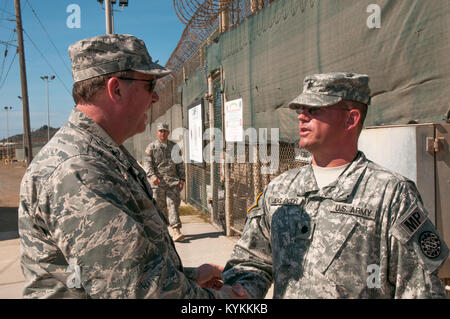 Air Force, le général Edward Tonini, adjudant général de l'état du Kentucky, le Lieutenant-colonel de l'Armée accueille Michael Shoen, commandant adjoint de la détention conjointe Groupe, en dehors de l'entrée des véhicules du camp VI à la station navale des États-Unis à Guantanamo Bay, Cuba le 3 décembre 2013. Tonini est venu à l'île à visiter avec des gardes du Kentucky déployés à GTMO à l'appui d'opérations d'affaires publiques. Army National Guard (photo par le Sgt. David Bolton/Mobile 133e Détachement des affaires publiques/Groupe de travail conjoint-GTMO Affaires publiques) Banque D'Images