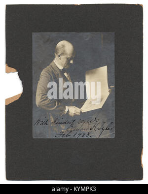 Photographie historique de 1908 de Bayard H. Tyler, figure influente du début du XXe siècle. L'image capture Tyler en position assise posée, portant un costume et un noeud papillon, dans un moment de contemplation. Banque D'Images