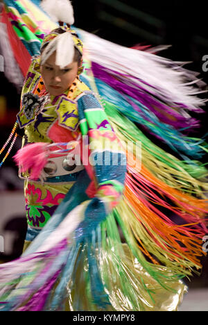 Une photographie vibrante du Powwow de 2007, montrant une danseuse amérindienne dans une tenue traditionnelle colorée, dans le cadre d'une célébration culturelle et historique. Banque D'Images