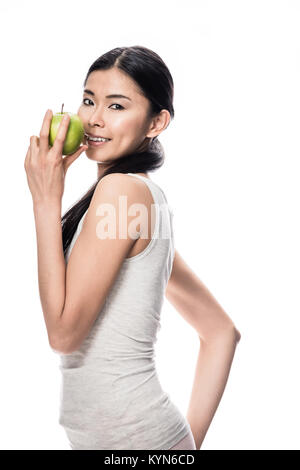 Happy Asian woman holding a green apple Banque D'Images