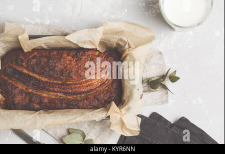 Pain aux bananes entières dans un plat allant au formulaire. Fond gris. Vegan Aliments sains Concept. Vue d'en haut. Banque D'Images