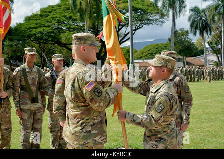 Le col Shannon-Mikel Lucas passe la 8e Brigade de police militaire de la brigade de couleurs entrant senior advisor enrôlé, commande le Sgt. Le major William Mayfield, lors d'une cérémonie de changement de responsabilité le 9 janvier à Schofield Barracks' Hamilton Field. (U.S. Army Banque D'Images