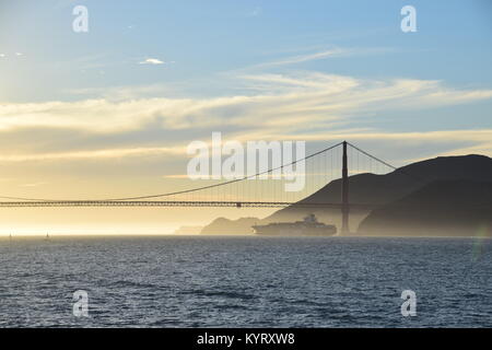 Porte-conteneurs NYK Constellation quitte San Francisco Bay sous le Golden Gate Bridge vers le coucher du soleil.